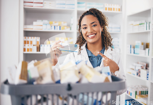 Image of Pointing, pharmacy or portrait of happy woman with medicine in healthcare retail or wellness clinic. Smile, help desk or pharmacist doctor smiling to promote medication products or pills in drugstore