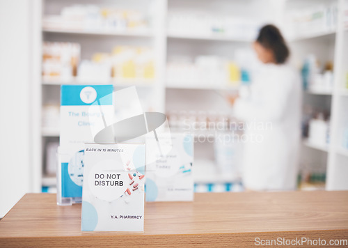 Image of Employee break, pharmacy sign and shop poster of an busy retail board in healthcare store. Medical, wellness and doctor practice with a do not disturb placard and billboard on worker desk at clinic