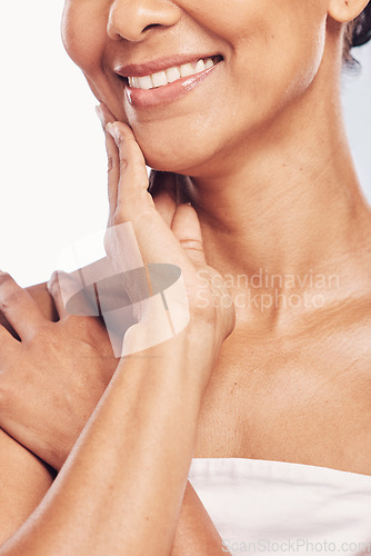 Image of Hand, mouth and beauty with a senior woman in studio for skincare, anti aging treatment or cosmetics. Skin, facial and wellness with a mature female moisturizing her face for hydration closeup