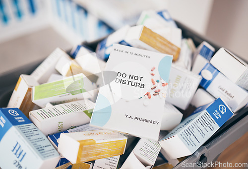 Image of Sign, healthcare and medicine in an empty pharmacy for the treatment or cure of disease and insurance. Do not disturb, medical and medicine box, package or container in a pharmaceuticals clinic