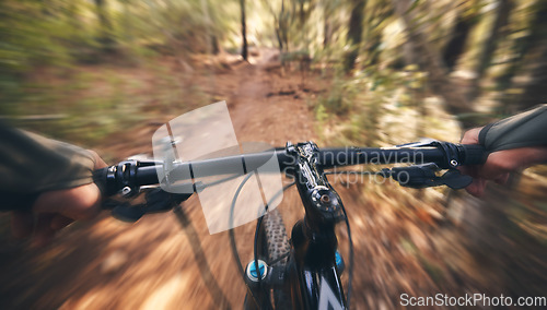 Image of POV, mountain bike and person cycling in forest, park and path for adventure, speed and motion blur. Closeup perspective of bicycle handle, athlete and outdoor action in nature, off road and sports