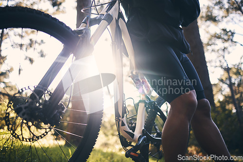 Image of Closeup man, bike and flare in nature, park and sports adventure of freedom, athlete and sunshine. Cycling, bicycle and cyclist on a break outdoor for fitness, cardio exercise and training for action