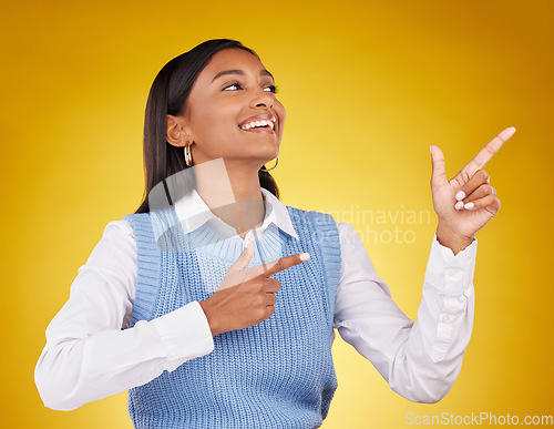 Image of Woman, portrait and gun fingers in a studio pointing with emoji hand gesture with a smile. Happiness, business female and happy youth with proud and cool hands sign in isolated yellow background