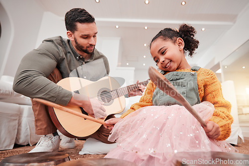 Image of Family, children or fantasy band with a father and daughter playing music together on instruments at home. Kids, love or bonding with a man and girl child having fun in the living room of their house