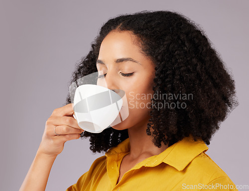 Image of Calm woman, coffee and drinking in studio, backdrop and background for warm beverage, latte and taste of espresso. Female model enjoying cup of tea, cappuccino and good mood for break, relax or peace