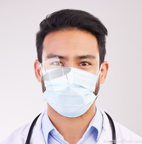 Image of Covid, doctor and portrait of man in studio with protection, safety or corona compliance on white background. Face, mask and male healthcare worker at hospital for treatment and disease prevention