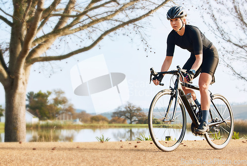 Image of Fitness, bicycle and woman cycling in a forest for sports, exercise and morning cardio in nature. Training, bike and female enjoying workout in a park, freedom and energy, performance and endurance