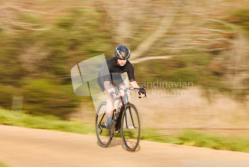 Image of Bicycle, sports and woman cycling in a forest for fitness, exercise and morning cardio in nature. Training, bike and female workout in a park, freedom and energy, performance and intense endurance