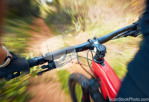 Image of Bike, cycling and motion blur with a sports person holding handle bars while riding outdoor closeup pov. Bicycle, fitness and speed with a cyclist or athlete mountain biking in nature during summer