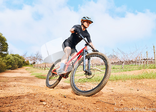 Image of Bicycle, fitness outdoor and woman on a cycling with freedom for sports race on gravel road. Fitness, exercise and athlete doing sport training in nature on park trail for cardio and healthy workout