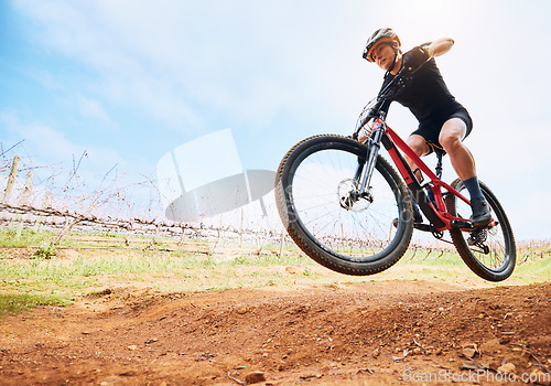 Image of Bicycle, countryside and woman on a bike with speed for sports race on a dirt road. Fitness, exercise and athlete doing sport training in nature on a park trail for mockup cardio and cycling workout