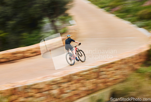 Image of Cycling man, speed and bicycle in nature on countryside bridge for training, wellness and fitness. Cyclist, mountain bike and sustainable travel in summer for adventure, health and workout on road