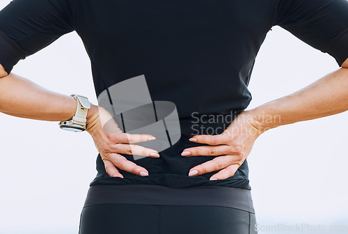 Image of Hands, woman and back pain during fitness, training or workout routine outdoors, discomfort and sore. Spine, issue and female with sports injury, problem and ache, fibromyalgia or accident