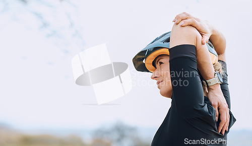 Image of Sports, cycling and arm stretch by woman outdoors for training, exercise and warm up. Start, stretching and female cyclist prepare for fitness, cardio and routine in the countryside, calm and content