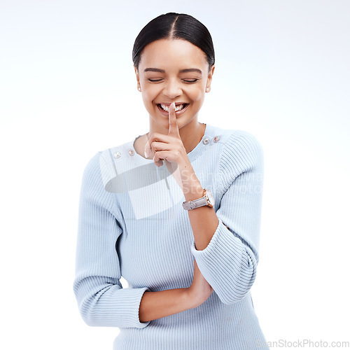 Image of Woman, secret and studio with finger on lips emoji and a smile for confidential news and gossip. Isolated, white background and young female with a laugh and happiness from announcement and privacy