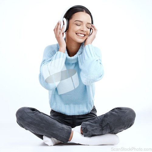 Image of Music headphones, woman and smile in white background, isolated studio and floor. Happy female model listening to sound, streaming album and audio connection of song, podcast subscription and radio