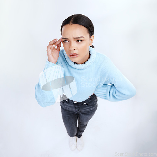 Image of Thinking, above and woman in a studio feeling frustrated and confused from planning question. Isolated, white background and young person with stress, anxiety and burnout alone while in doubt