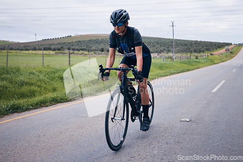 Image of Fitness, cycling and man on a bicycle in nature training for a race, marathon or competition. Sports, workout and male athlete cyclist riding a bike for cardio exercise on a road in the mountain.