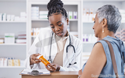 Image of Black woman, doctor and prescription medication for patient or over the counter pills at pharmacy. African medical pharmacist consulting senior client for dosage, symptoms or side effects at clinic