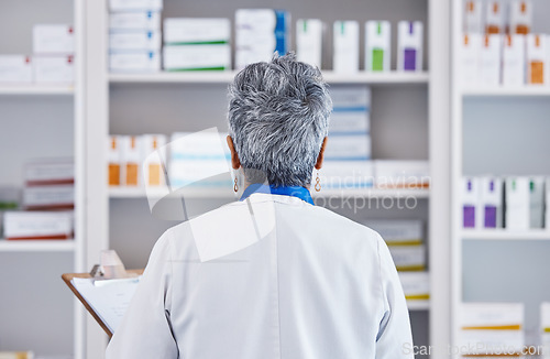 Image of Back, pharmacy and checklist with woman in store for inventory, medicine and shelf stock. Retail, shopping and healthcare with pharmacist and clipboard for medical, prescription and product