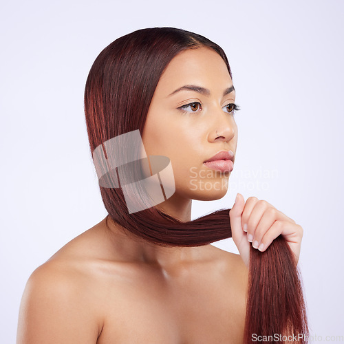 Image of Haircare, beauty and woman holding hair, straight hairstyle and luxury salon shine isolated on white background. Haircut, keratin glow and serious expression of Brazilian model in studio backdrop.