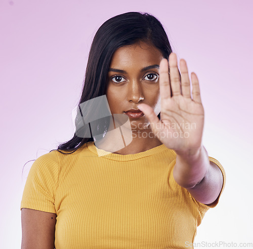 Image of Portrait, stop and hand by woman in studio for warning, rejection or sign on gradient purple background. Face, symbol and protest hands by girl with body language for refuse, no and forbidden emoji