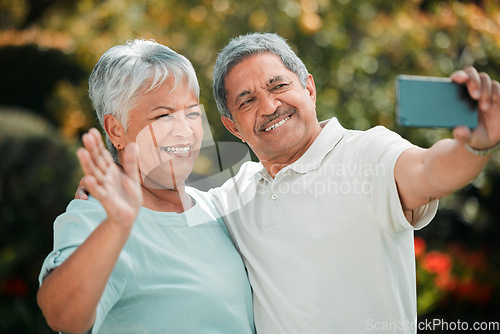 Image of Senior couple, video call and phone in park, garden and contact on mobile voip communication. Retirement, old man and happy woman wave for selfie, smartphone and smile for hello, chat or online media