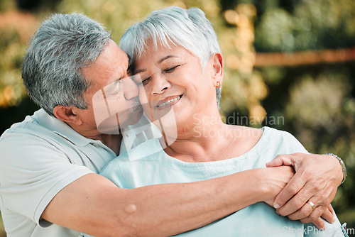 Image of Senior couple, kiss and hug in park, garden and nature for love, care and happiness together. Happy man, woman and retirement of loving partner, relax and support in marriage, quality time or outdoor