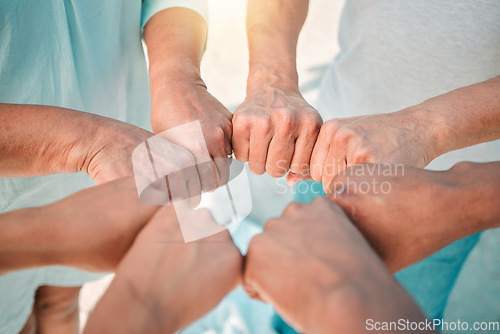 Image of Hands, teamwork and solidarity with people in a huddle together outdoor closeup from above for unity. Collaboration, support and trust with a team or group standing in a circle for motivation