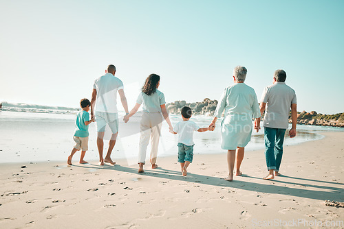 Image of Big family, holding hands and walking outdoor on beach with children, grandparents and parents . Men, women and boy kids walk by sea for summer travel vacation or holiday with love, care and support