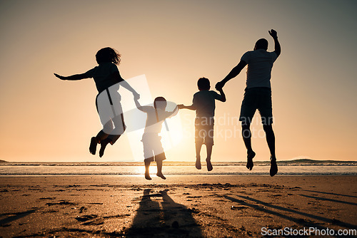 Image of Beach silhouette, sunset and a family jump for freedom, summer energy or travel. Happy, nature and back of a mother, father and children holding hands while jumping at the ocean for celebration