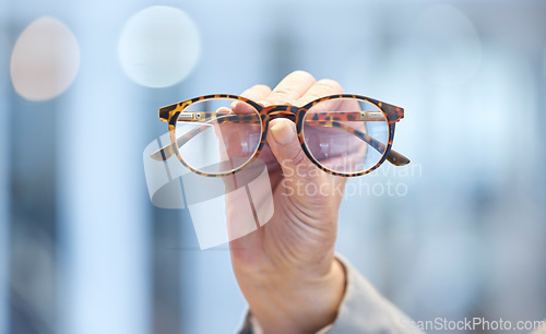 Image of Optometry, vision and optometrist hand with glasses for eye care, optical wellness and healthcare. Medical, optic and closeup of woman with spectacles with stylish frame and prescription lens in shop