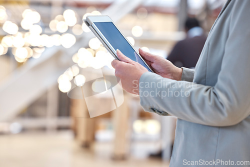 Image of Hands, business and typing on tablet screen in office, social media or research in workplace. Technology, bokeh and professional person or woman browsing online, networking app or internet scrolling.