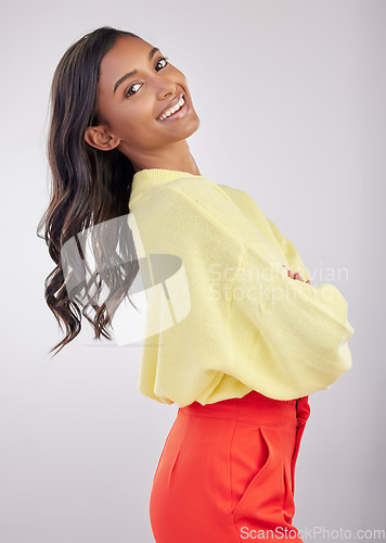 Image of Happy, confident and the portrait of a woman with arms crossed isolated on a white background. Smile, stylish and a girl standing with empowerment, positivity and confidence on a studio backdrop