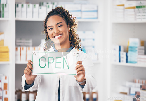 Image of Open, business sign and woman portrait in a pharmacy with billboard from medical work. Working, pharmacist and healthcare worker with a smile from retail store opening and small business poster