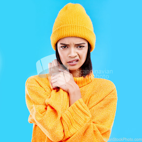 Image of Portrait of woman in winter fashion with doubt, beanie and attitude isolated on blue background. Style, confused face of gen z girl and studio backdrop, model in warm clothes for cold weather mockup.