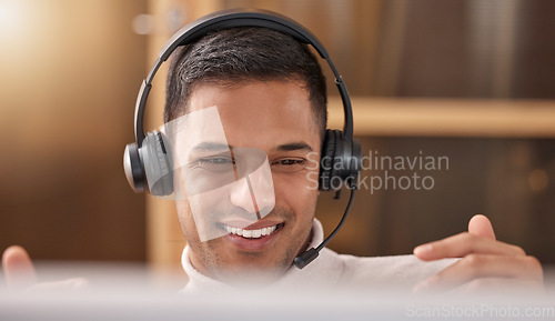 Image of Call center, man and happy with smile on face at desk in office for sales and customer support, Male agent or consultant in telemarketing, support and crm with headphones for help desk communication