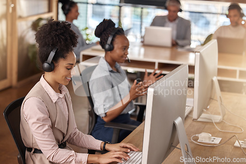 Image of Call center, team and computer on desk in office for customer service, sales or support. Happy people, agents or consultant in night telemarketing, telecom and crm or help desk in coworking workplace