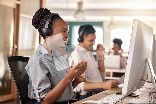 Image of Call center, woman and smile at computer for telemarketing, sales and global support. Professional female consultant or agent with a headset and team for customer service, crm and help desk advice