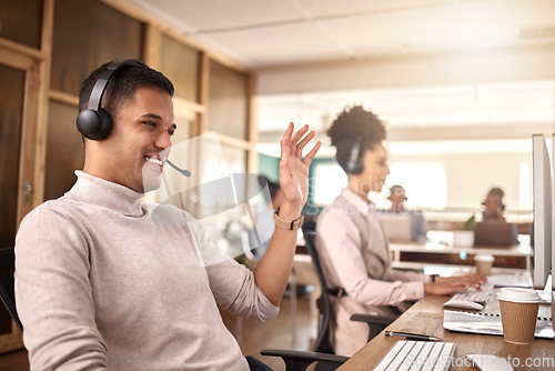 Image of Businessman, call center and meeting on computer in customer service, support or telemarketing at the office. Happy man, consultant or agent talking with smile, headphones or waving for online advice