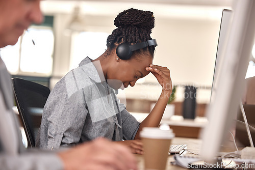 Image of Call center, woman and stress or headache at computer in office and tired of sales or customer service. African female agent or consultant in telemarketing, support and crm with mental health burnout