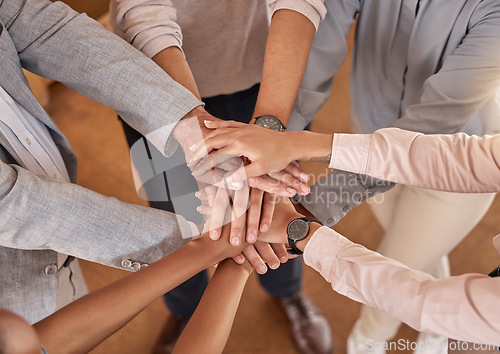 Image of Business people, hands and teamwork in collaboration above for meeting trust, unity and community at office. Top view of group piling hand together for celebration, success or workplace team building