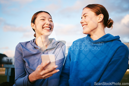 Image of Laugh, women and friends with smartphone, outdoor and connection for social media, typing and smile. Female athlete, contact and happy girls outside, cellphone and mobile app for fun, meme and funny