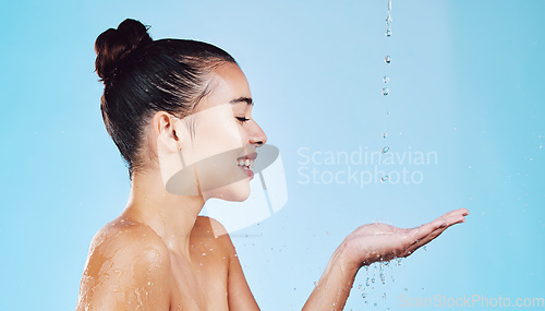 Image of Water drops, skincare and woman with mockup for health, wellness and hygiene isolated on blue studio background. Shower, dermatology and cosmetic beauty glow, model in skin care treatment or routine