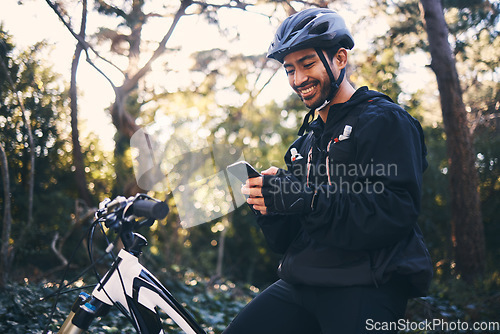 Image of Sports, man and phone outdoor for mountain bike, cycling or workout and smile in nature. Male person in forest with smartphone in hands for communication, gps travel app or fitness with safety gear