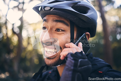 Image of Sports, face of man and phone call outdoor for cycling, mountain bike or workout and smile in nature. Male person in forest with smartphone for communication, contact or talking fitness with helmet