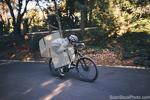 Image of Cycling, nature and relax with man on road for training, workout or cardio exercise. Adventure, extreme sports and speed with male cyclist on bike in forest park for performance, challenge or break