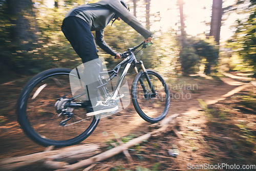 Image of Cycling, speed and man on a bicycle on a dirt forest road doing training and exercise on a bike. Fast, outdoor trail and athlete with energy on a nature adventure or fitness on a path