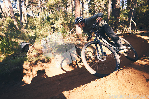 Image of Fitness, bicycle hill and man outdoor on a forest path with extreme and exercise adventure. Bike, cycling and sport of an athlete with fast speed and nature cycle for sports training and race action