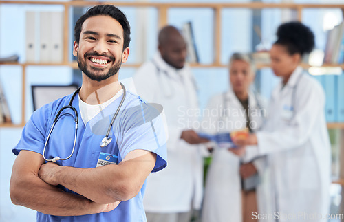 Image of Hospital, doctor and portrait of man in healthcare clinic for insurance, wellness and medical service. Medicine, professional and health worker smile with crossed arms for care, consulting and help